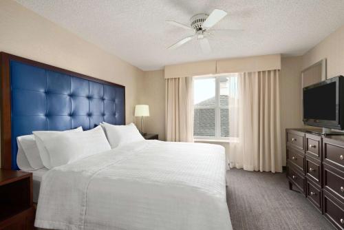 a bedroom with a large bed and a television at Homewood Suites by Hilton Wilmington-Brandywine Valley in Talleyville