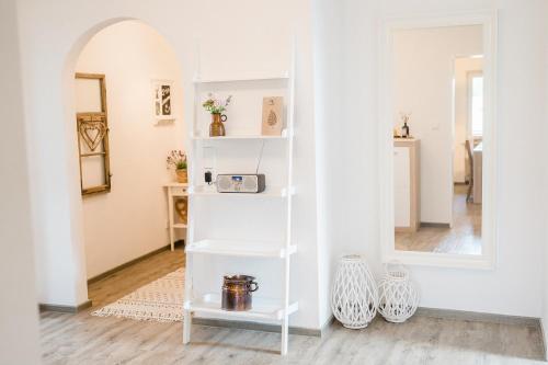 a white shelf in a room with a mirror at Ferienwohnung - Haus am Sonnenhang in Wertach