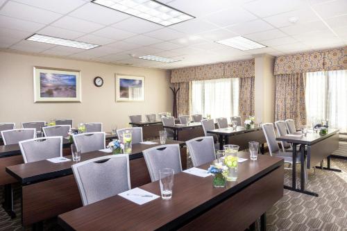 a conference room with tables and chairs and windows at Hampton Inn Winston-Salem Hanes Mall in Winston-Salem