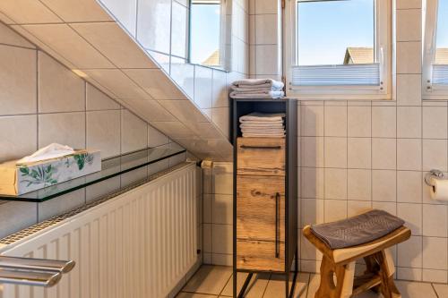 a small bathroom with a staircase and a stool at Haus Unterseeblick Sonnenuntergang in Gaienhofen