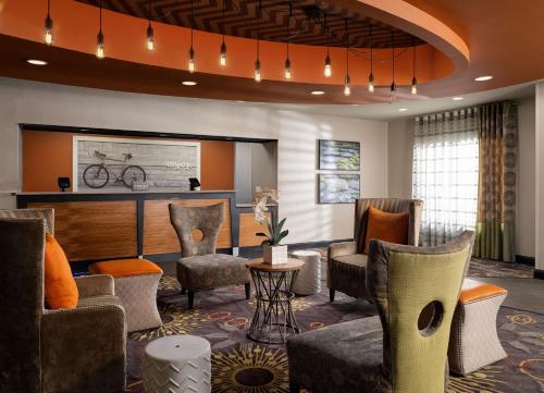 a hotel lobby with chairs and a bike on the wall at Hampton Inn Clinton in Clinton