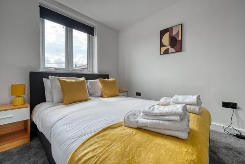 een slaapkamer met een groot bed en handdoeken bij Aryas Homes Oxford - Headington in Oxford