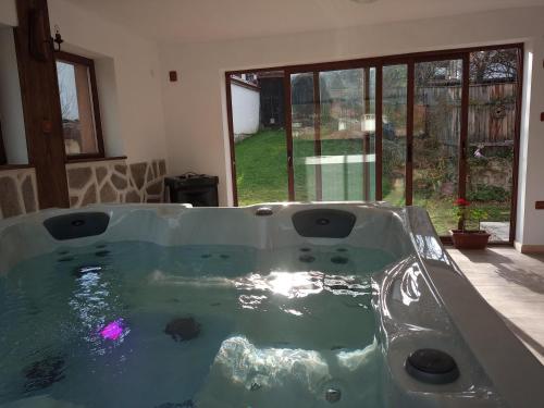a large bath tub in a room with a window at Villa Lyutovi Holiday Home in Koprivshtitsa