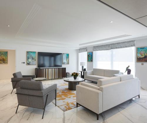 a living room with couches and a flat screen tv at Sanctum Regent's Park in London