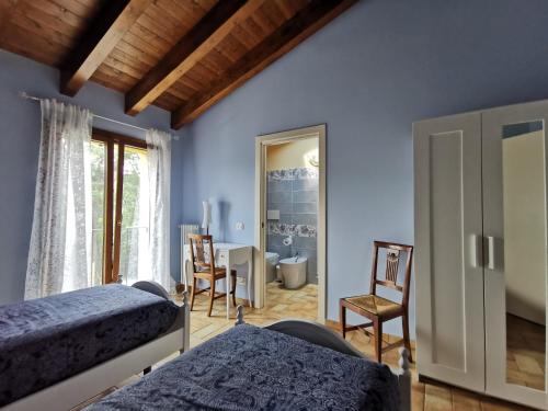 a bedroom with two beds and a table and chairs at Luci nel Bosco 