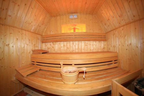 a inside of a wooden sauna with a bucket at Retro Hostel in Cluj-Napoca