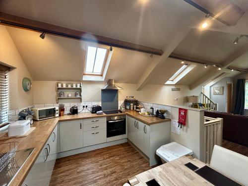 a kitchen with white cabinets and a counter top at Tanyard Barn - North Yorkshire in York
