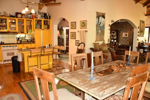 a kitchen and living room with a wooden table at Triple Room Bed and Breakfast main House in Guillet