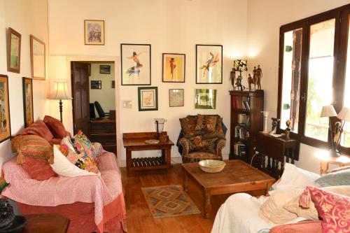 a living room with two chairs and a table at Triple Room Bed and Breakfast main House in Guillet