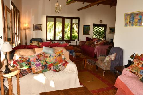 a living room with couches and chairs in it at Triple Room Bed and Breakfast main House in Guillet