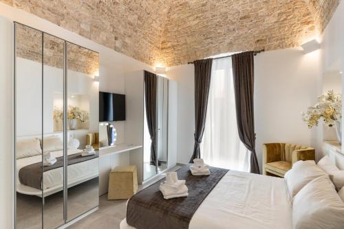 a hotel room with a bed and a couch at Casa Massima Suites & SPA in Casamassima