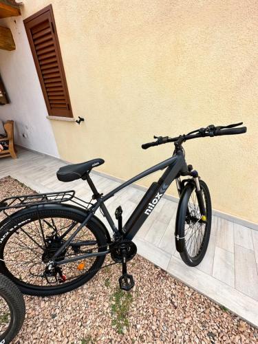 a black bike parked next to a building at Molti Mari B&B Resort in Olbia