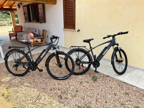 two bikes are parked next to a house at Molti Mari B&B Resort in Olbia