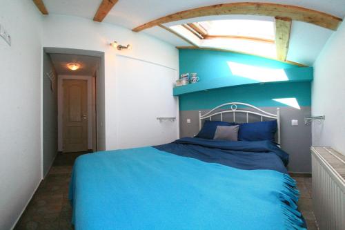 a bedroom with a blue bed in a room at Retro Hostel in Cluj-Napoca