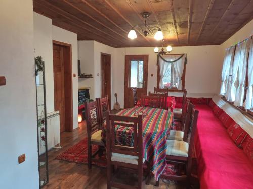 a dining room with a table and chairs at Villa Lyutovi Holiday Home in Koprivshtitsa