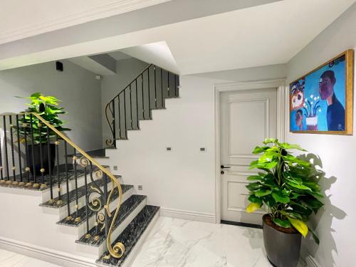 a staircase in a home with white walls at Apartments by Vitrine in Hanoi
