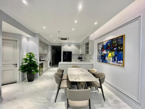 a kitchen and dining room with a table and chairs at Apartments by Vitrine in Hanoi