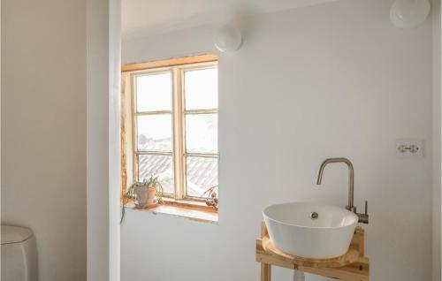 a bathroom with a sink and a window at Beautiful Apartment In Vanse With House Sea View in Vanse