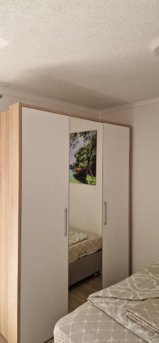 a bedroom with two white closets and a bed at Villa Bali - Aladinici in Stolac
