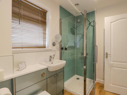 a bathroom with a sink and a shower at Knockendoch in Dumfries