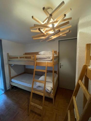 a room with bunk beds and a ceiling fan at Appartement pied des pistes Champagny-en-Vanoise in Champagny-en-Vanoise