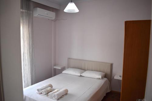 a bedroom with a bed with two towels on it at Giorgos house in Nea Kalikratia
