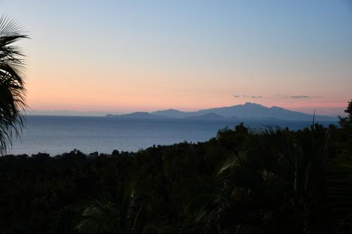 a view of the ocean and mountains at sunset at Triple Room Bed and Breakfast main House in Guillet