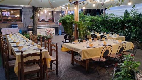 a set of tables in a restaurant with umbrellas at Hotel Ristorante Stella in Palestrina