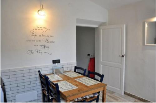 a dining room with a table and a white wall at Suite La Corte in Florence