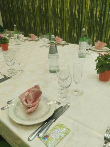 a table with glasses and a plate of meat on it at Hotel Ristorante Stella in Palestrina