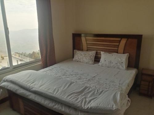 Postel nebo postele na pokoji v ubytování Al Hussain Family Apartments