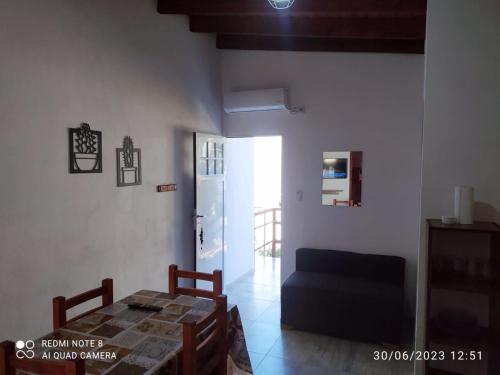 a living room with a table and a blue couch at Departamento Rosales Nro 2 in Valeria del Mar