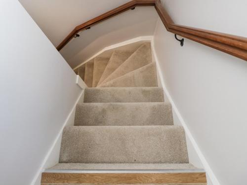 a staircase leading up to the basement of a house at Lakeside Mill Cottage in Stroud