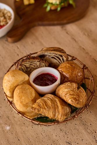 a plate of pastries and dipping sauce on a table at Makani Luxury Wanderlust in Tierra Bomba