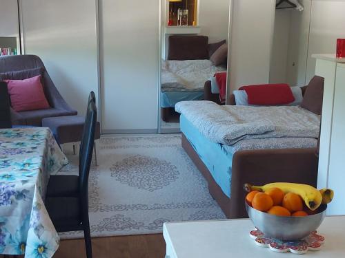 a room with a bowl of fruit on a table at Indy in Travnik