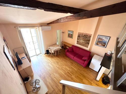 a living room with a red couch and a table at Résidence 3 Massena in Nice