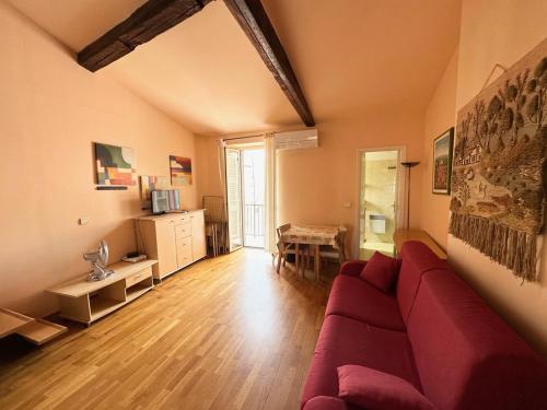 a living room with a red couch and a table at Résidence 3 Massena in Nice