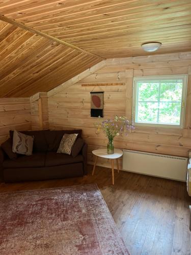 a living room with a couch and a window at Holiday Home Amero purnu 4 in Kolinkylä