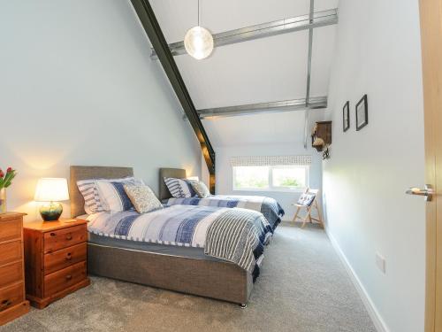 a bedroom with two beds and a window at The Shed in Liskeard