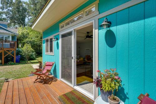 a blue house with a deck with a sliding glass door at 2 Mi to Duke University Durham Tiny Home! in Durham