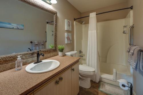 a bathroom with a sink and a toilet and a shower at Centrally Located Branson Condo Step-Free Access in Branson