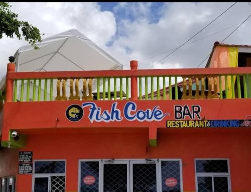 a fast food restaurant with a sign on the side of a building at Charming 1-Bedroom House in St Thomas Jamaica in Belfast