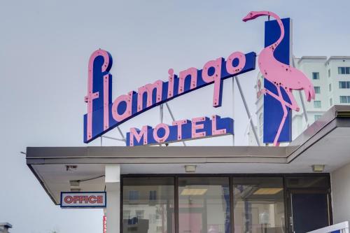 a neon sign on top of a laminated motel at Flamingo Motel in Ocean City