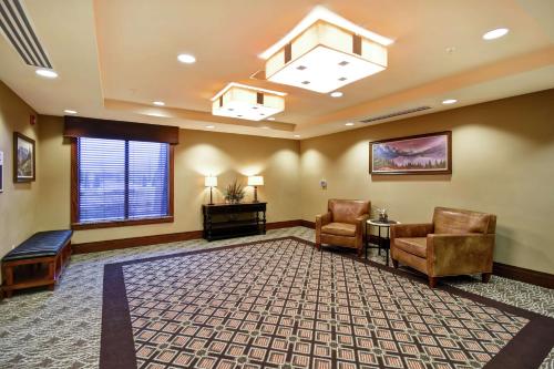 a waiting room with two chairs and a table at Homewood Suites by Hilton Kalispell in Kalispell