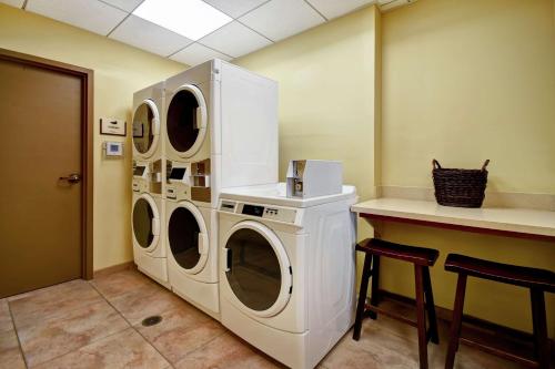 a laundry room with two washing machines and a counter at Homewood Suites by Hilton Kalispell in Kalispell