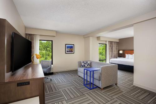 a hotel room with a bed and a flat screen tv at Hampton Inn Kingsport in Kingsport