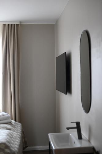 a bathroom with a sink and a mirror at Hotel Local 101 in Reykjavík