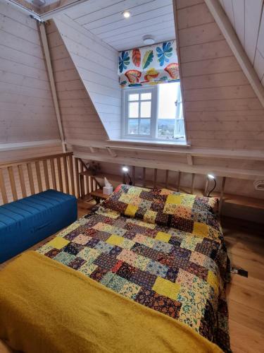 een slaapkamer met een dekbed op een zolder bij Square Oast Studio in West Malling