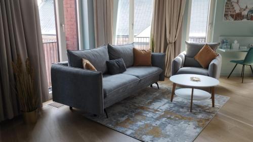 a living room with a couch and a table at Redstone Apartments in Rīga