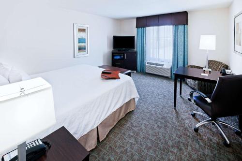 a hotel room with a bed and a desk at Hampton Inn & Suites Liberal in Liberal